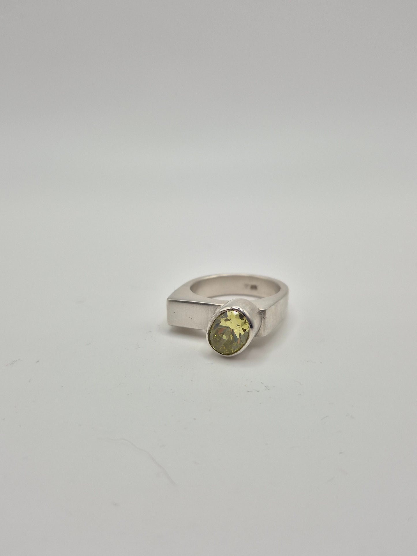 Acid green gemstone ring angle view showing modern minimalist design
