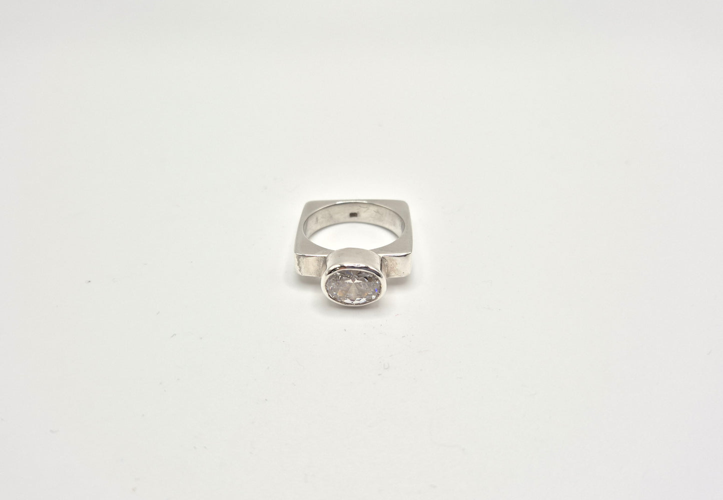 Cubic zirconia ring worn on white background