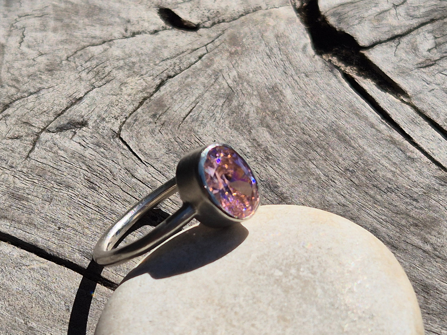 Angle view of slim band on pink CZ ring