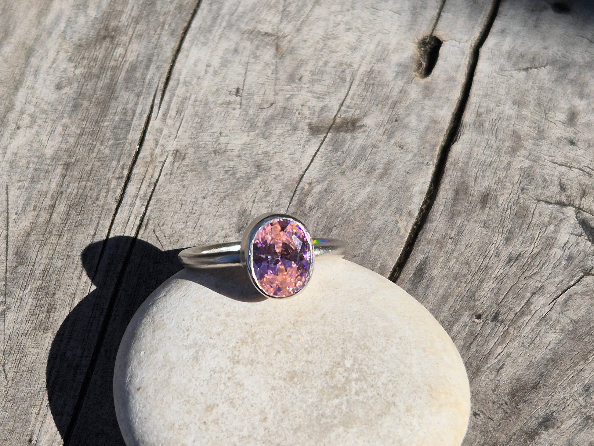 slim pink cz ring on a pebble
