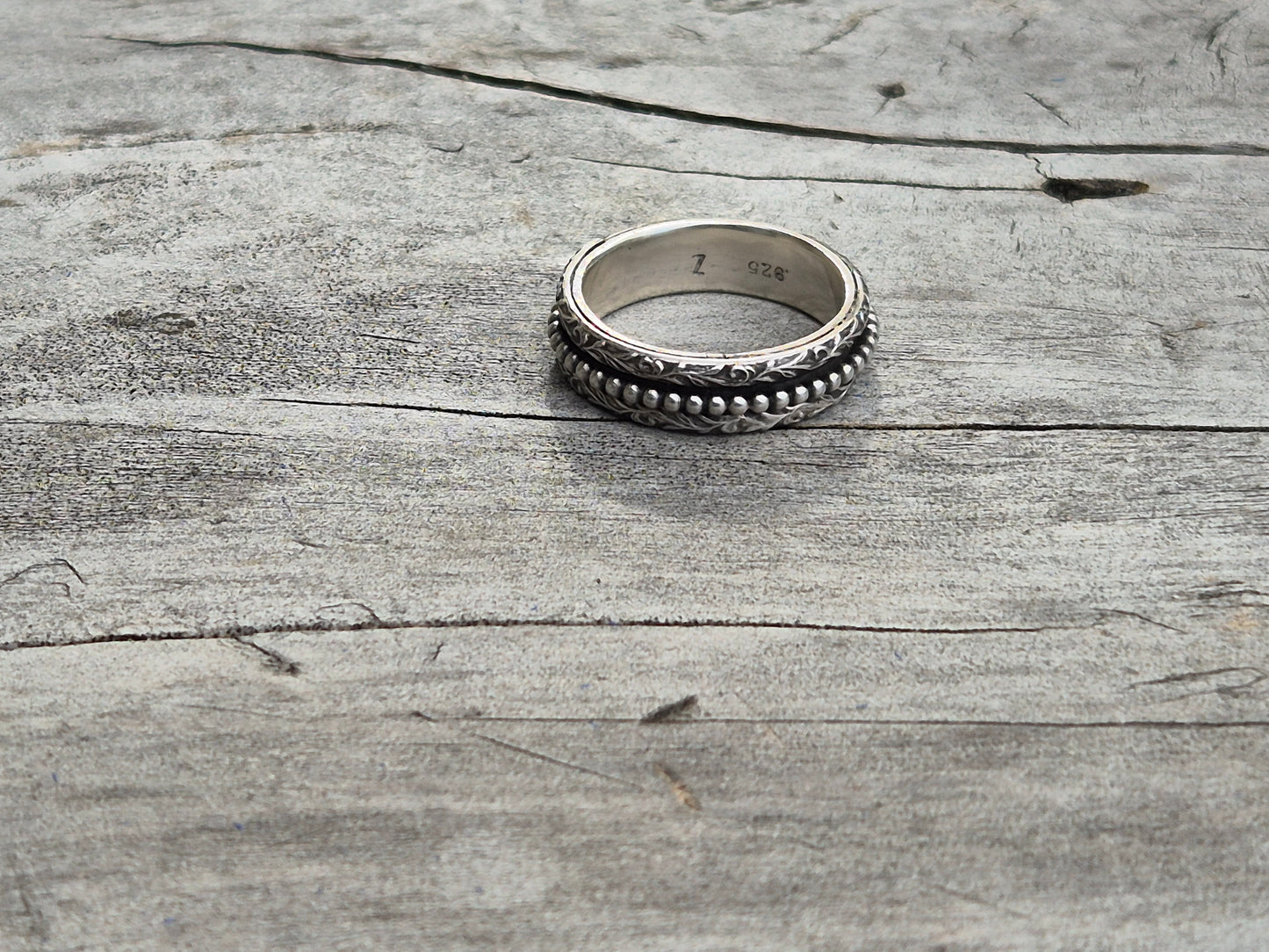 Spinner ring on wooden surface