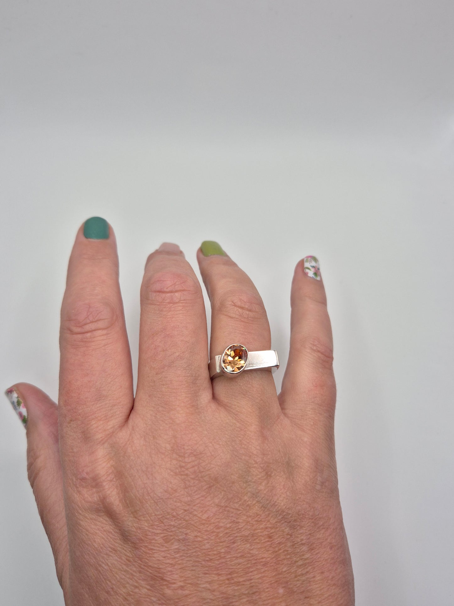 Sterling silver and champagne cubic zirconia ring worn on hand