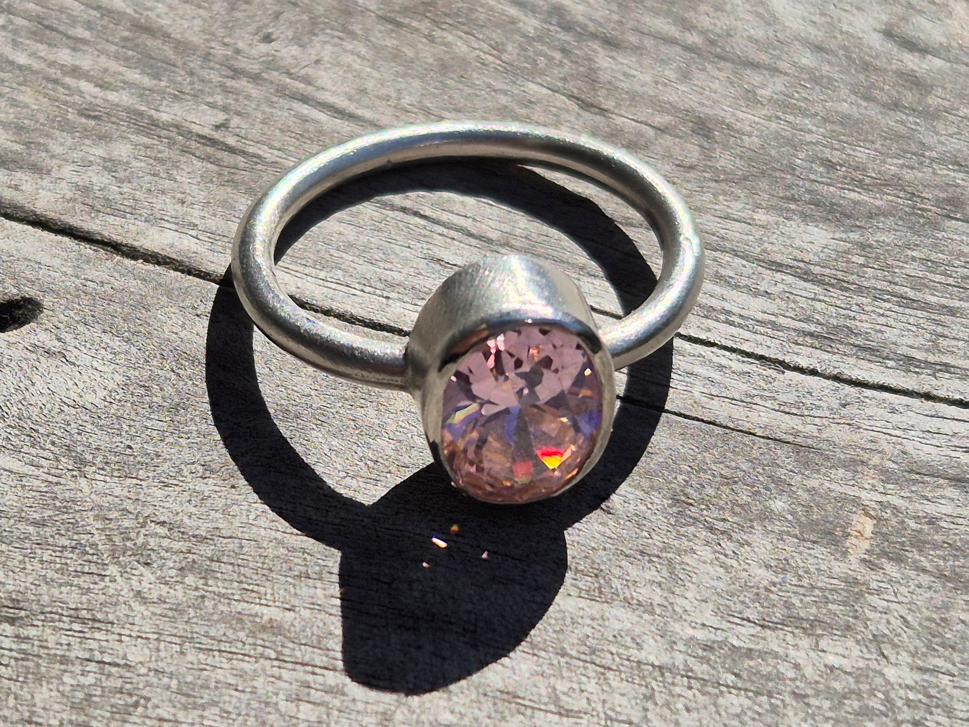 Pink cubic zirconia sterling silver ring detail, highlighting minimalist design