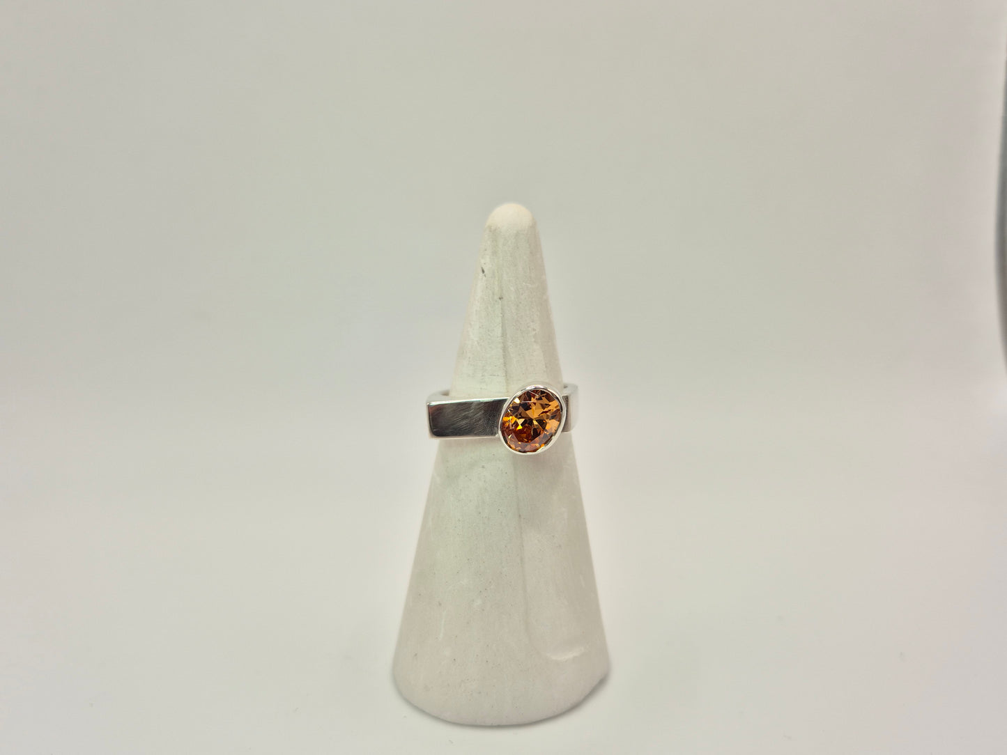 Sterling Silver and Champagne CZ ring on white ring cone.