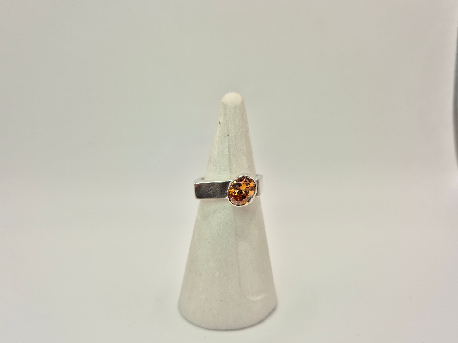 Sterling Silver and Champagne CZ ring on white ring cone.