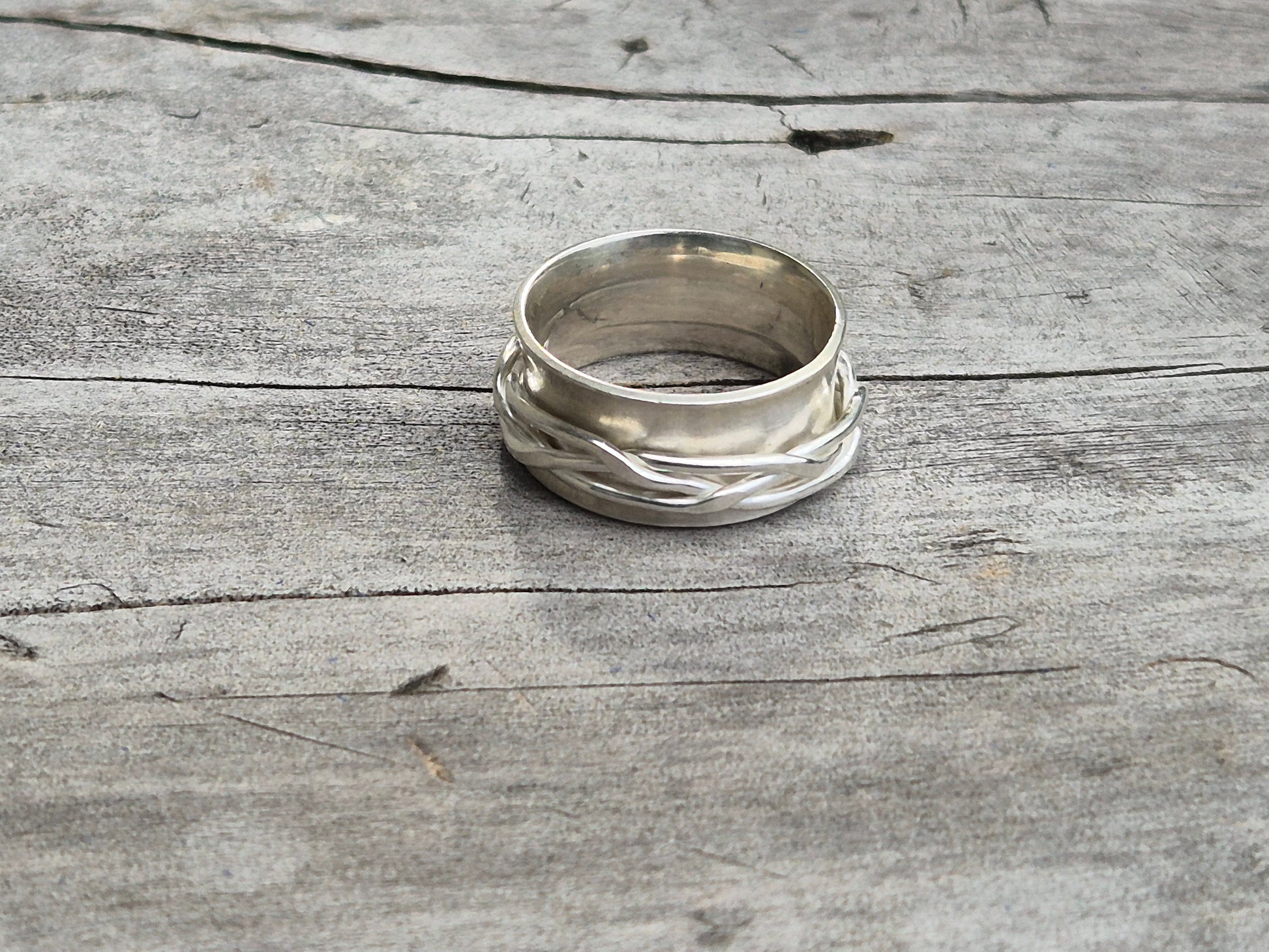 Sterling silver spinner ring with rotating woven band, fidget ring design